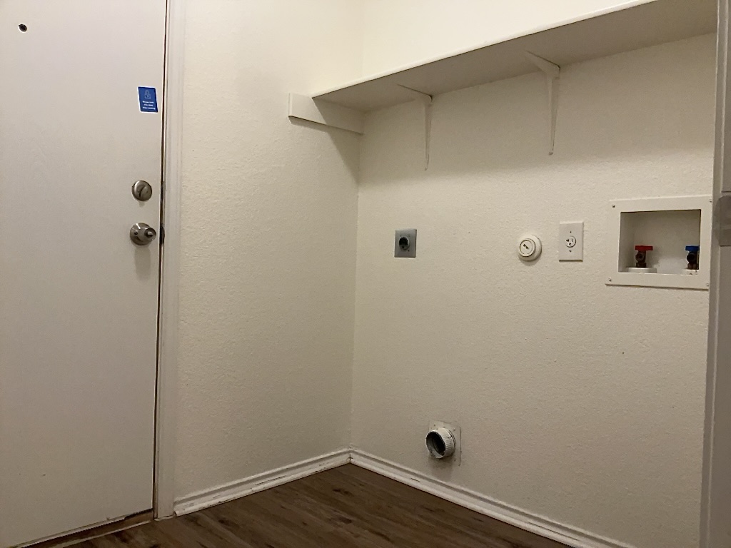 704 Big Sur Trail Taylor, TX 76574 - Photo 17 of 18 Laundry room featuring hookup for a gas dryer, electric dryer hookup, dark wood-style floors, and hookup for a washing machine