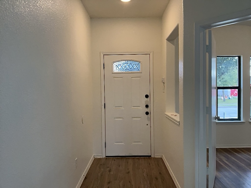 704 Big Sur Trail Taylor, TX 76574 - Photo 2 of 18 Doorway with wood finished floors and baseboards