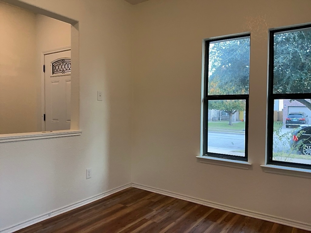 704 Big Sur Trail Taylor, TX 76574 - Photo 3 of 18 Empty room with dark wood-type flooring and baseboards