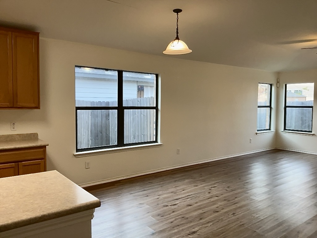 704 Big Sur Trail Taylor, TX 76574 - Photo 9 of 18 Unfurnished dining area with dark wood-style flooring