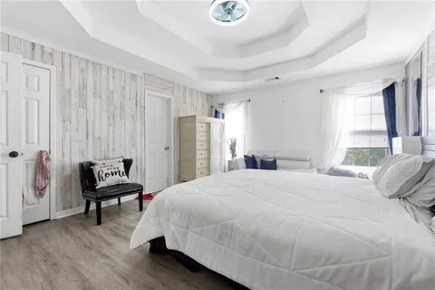 a bedroom with a bed and a chair