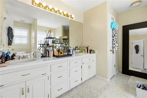 a bathroom with a double vanity sink and a mirror