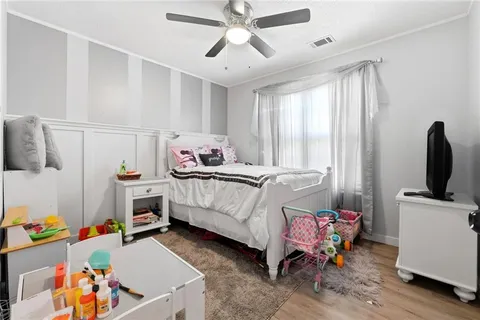 a bedroom with furniture a baby bed and a window