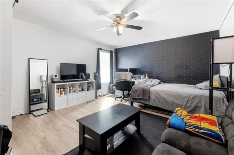 a bedroom with bed and a flat screen tv