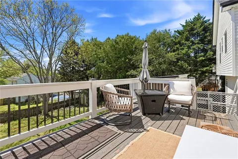 a view of a chairs and table on the roof deck