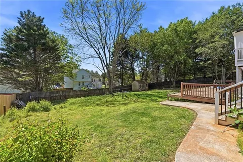 a view of a house with a yard and sitting area