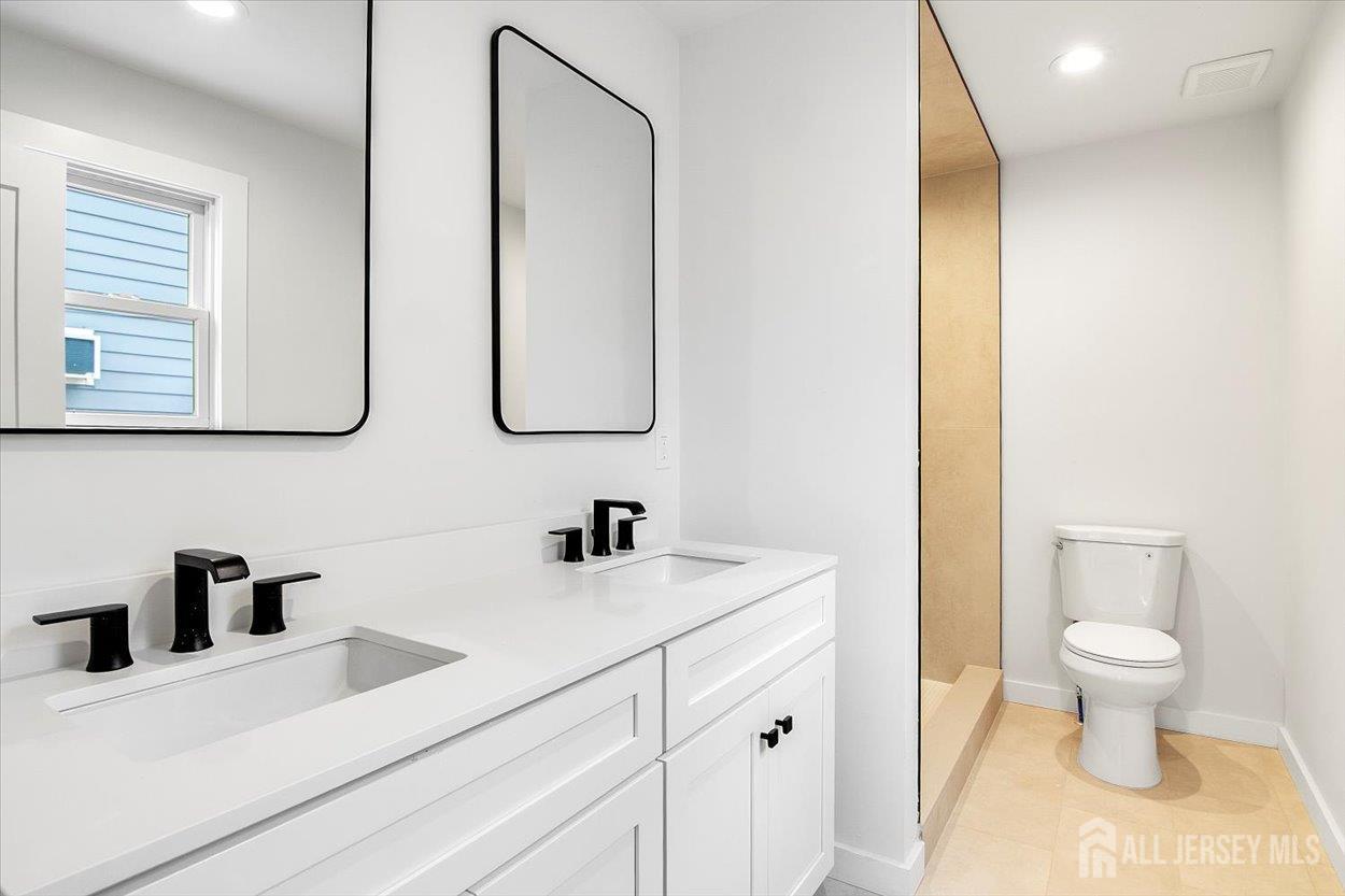 130 Ridge Road Colonia, NJ 07067 - Photo 15 of 28 a bathroom with a sink and a mirror