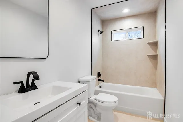 a bathroom with a sink a toilet and a bathtub