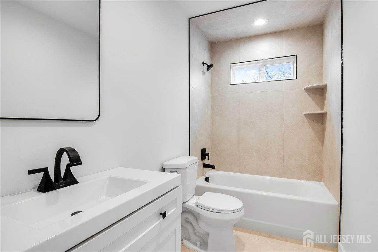 130 Ridge Road Colonia, NJ 07067 - Photo 20 of 28 a bathroom with a sink a toilet and a bathtub