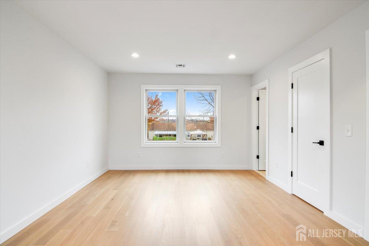 130 Ridge Road Colonia, NJ 07067 - Photo 22 of 28 a view of room with window and wooden floor