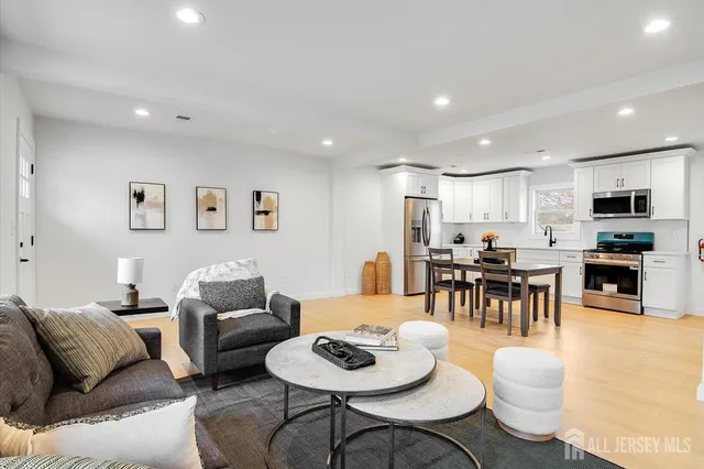 a living room with furniture and kitchen view