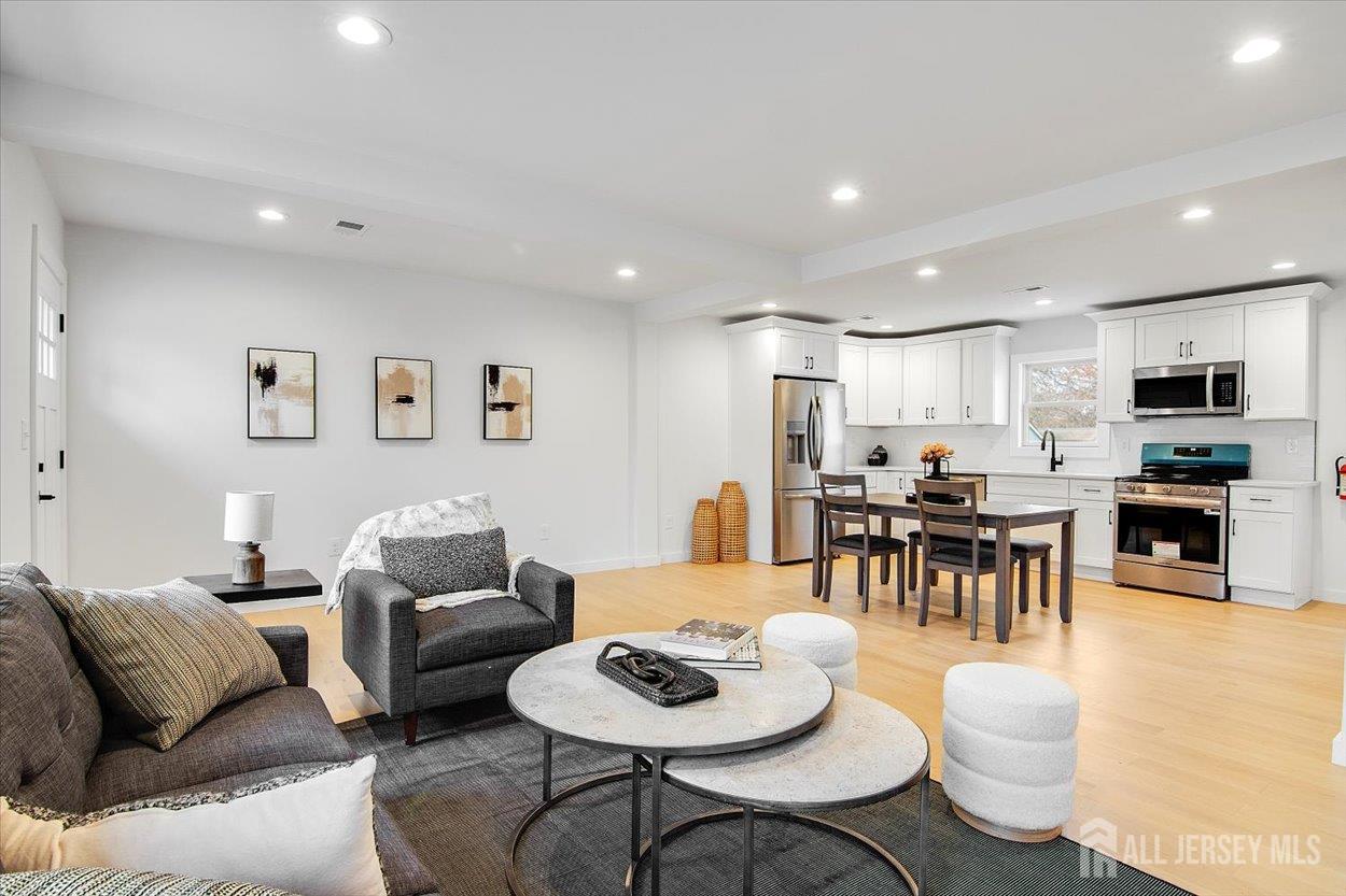 130 Ridge Road Colonia, NJ 07067 - Photo 6 of 28 a living room with furniture and kitchen view
