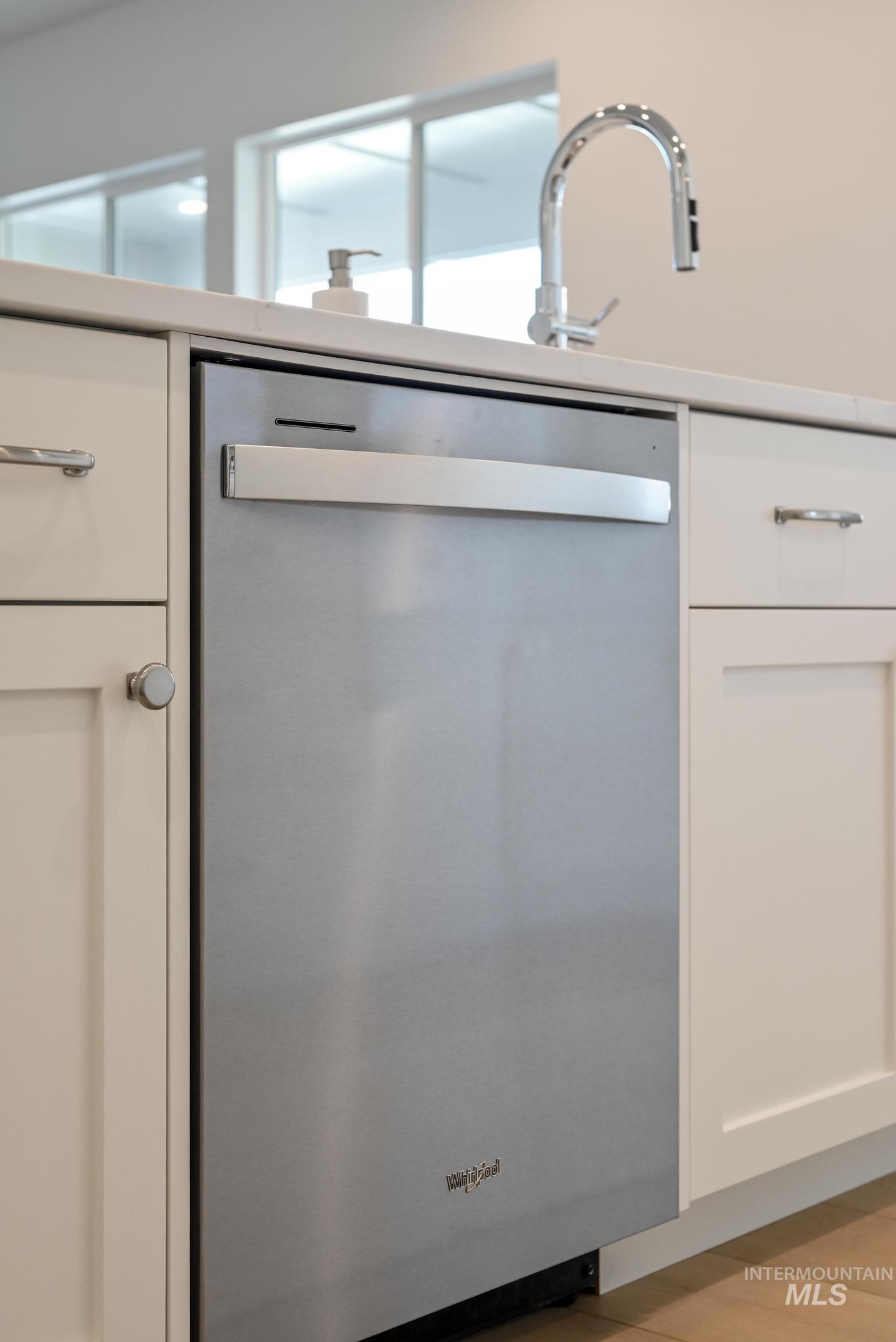 14676 Serenity Pt Street Caldwell, ID 83607 - Photo 14 of 41 Stainless steel dishwasher integrated within white shaker cabinetry