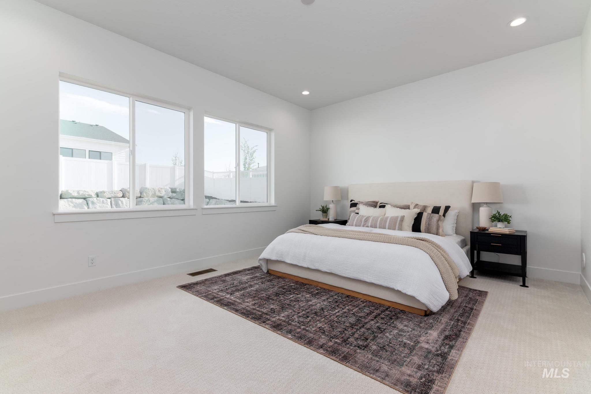 14676 Serenity Pt Street Caldwell, ID 83607 - Photo 19 of 41 Bright bedroom space featuring multiple large windows, recessed lighting, white walls, and light-toned carpeting