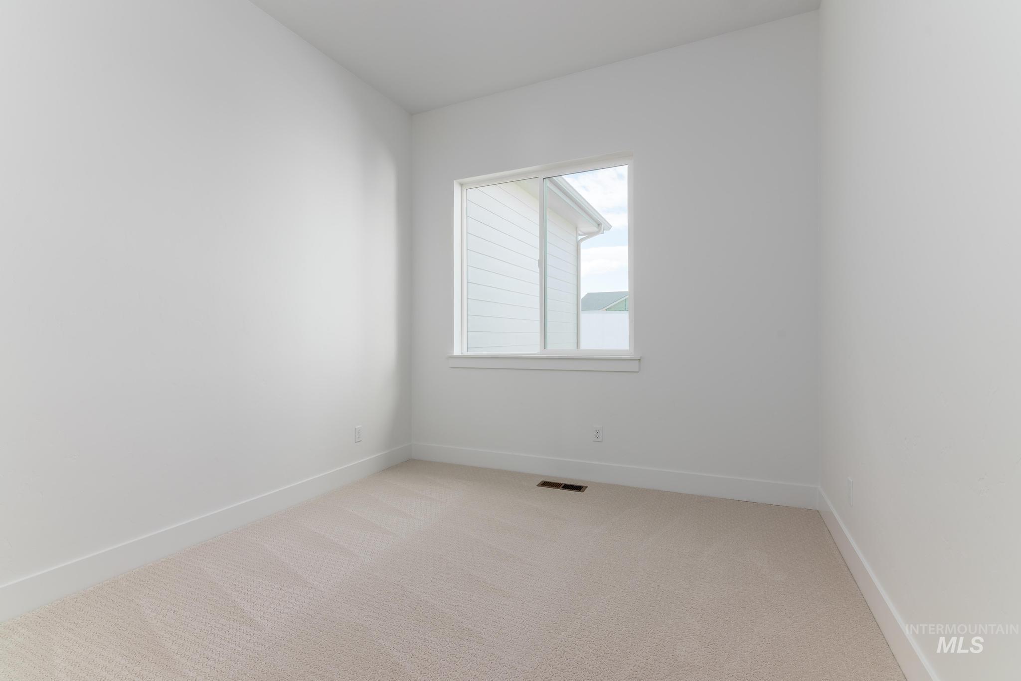 14676 Serenity Pt Street Caldwell, ID 83607 - Photo 23 of 41 Neutral tone carpeting, white painted walls, and white trim accents