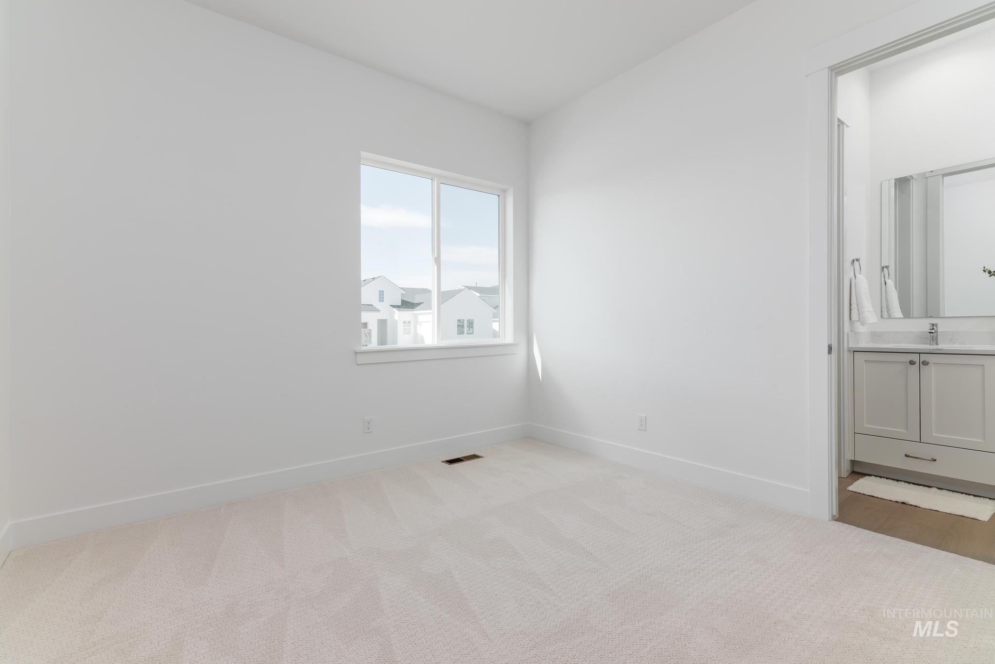 14676 Serenity Pt Street Caldwell, ID 83607 - Photo 24 of 41 Bright room featuring a large window, neutral carpet, and a white trim package