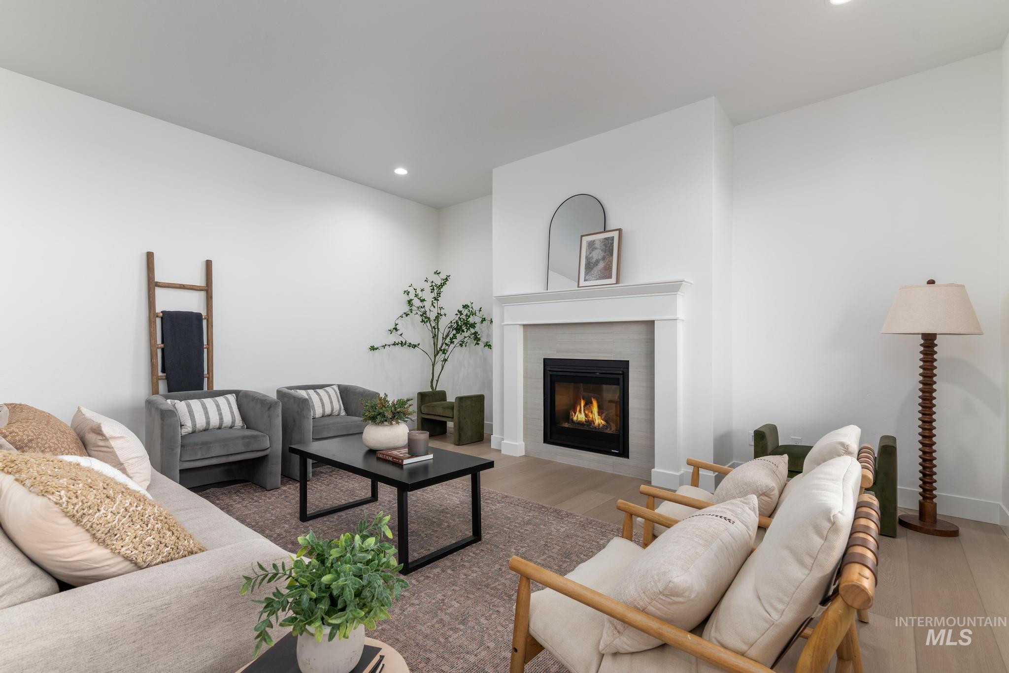 14676 Serenity Pt Street Caldwell, ID 83607 - Photo 5 of 41 Living area featuring a modern fireplace with a light-toned tile surround and a crisp white mantel