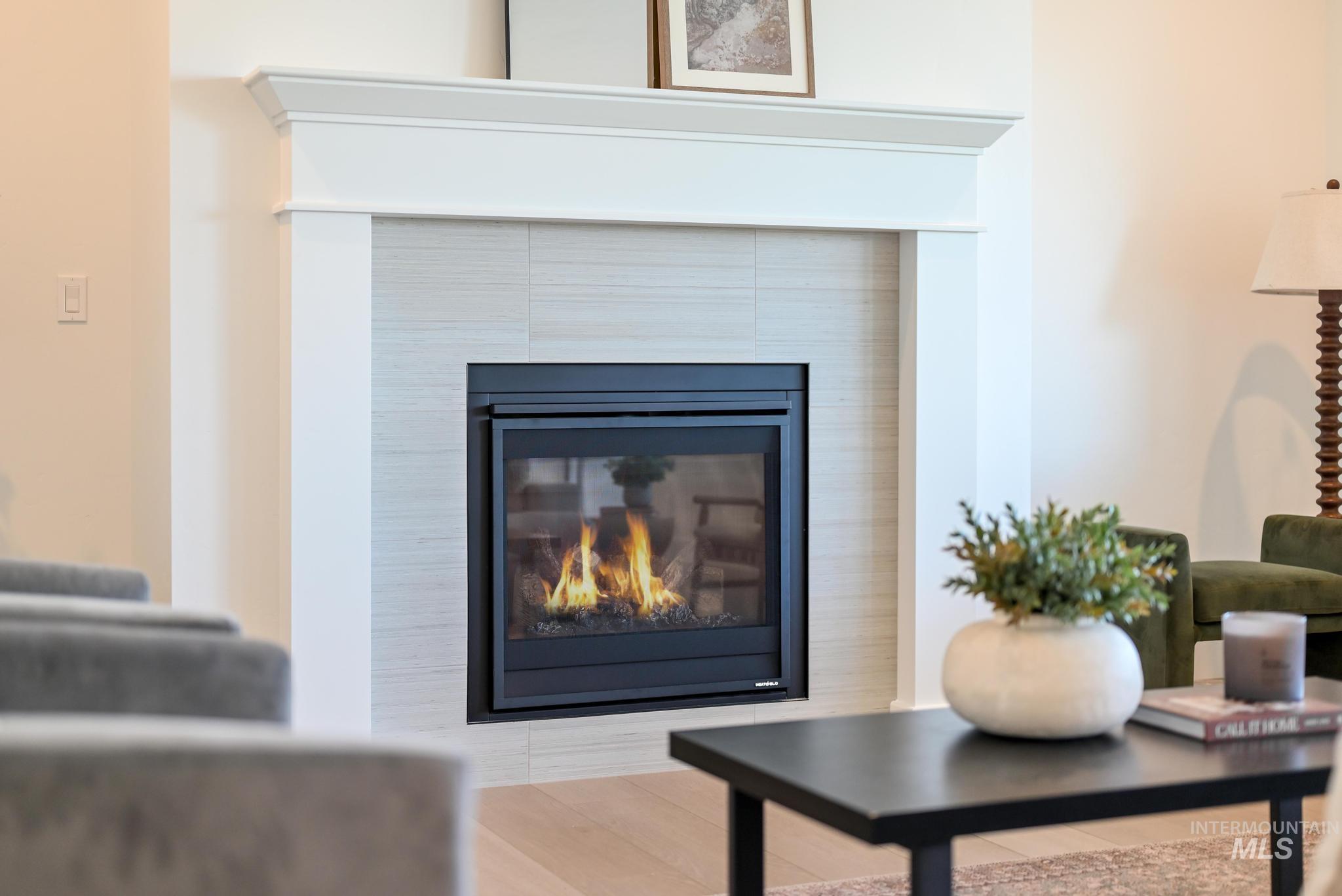 14676 Serenity Pt Street Caldwell, ID 83607 - Photo 7 of 41 Fireplace with a white mantel and tile surround