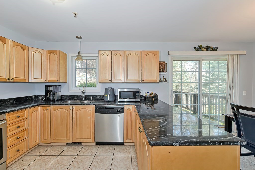 a kitchen with granite countertop a stove sink and cabinets