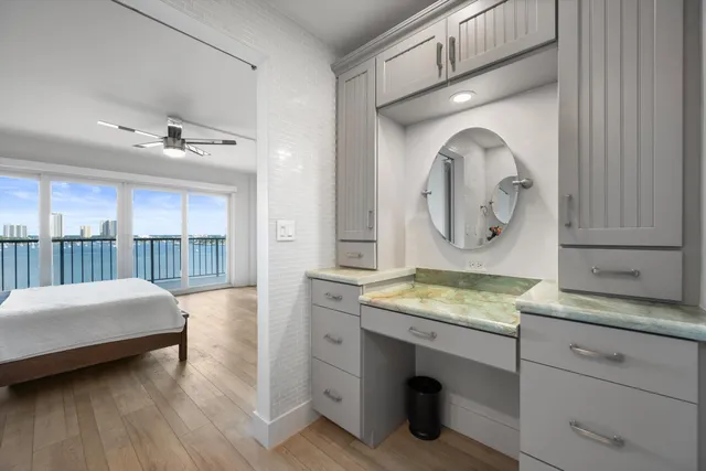 a en suite bathroom with a granite countertop sink and a mirror
