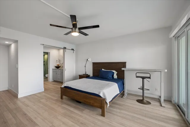 a bedroom with a bed and a table