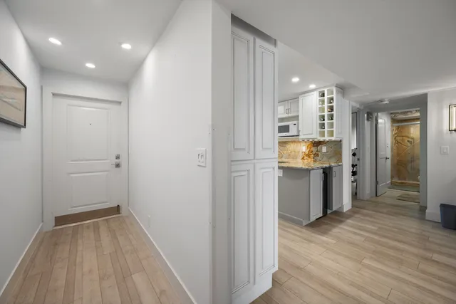 a view of a hallway with wooden floor