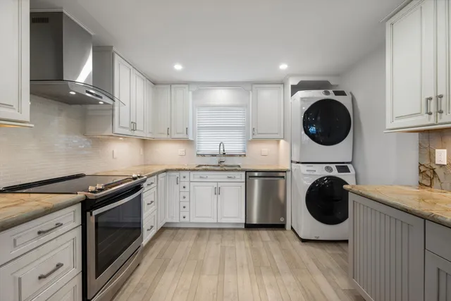 a kitchen with a stove a sink and a refrigerator