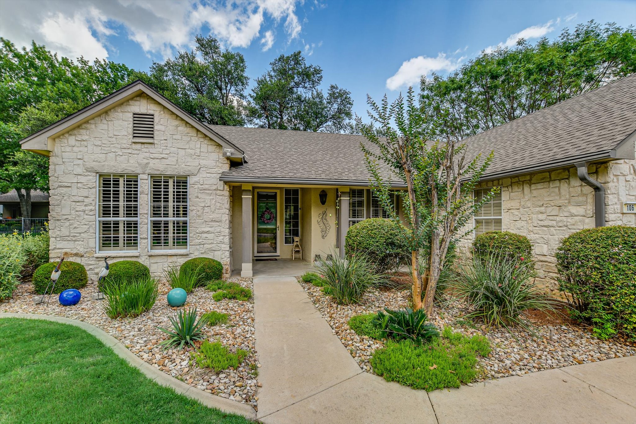 106 Nighthawk Way Georgetown, TX 78633 - Photo 2 of 29 A well-maintained facade with natural stone and a neatly landscaped front path offers charming curb appeal.