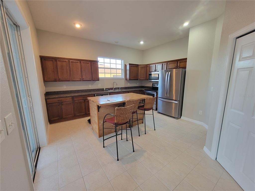 6243 Southwest 90th Street Ocala, FL 34476 - Photo 8 of 13 a kitchen with stainless steel appliances granite countertop a refrigerator and a stove top oven