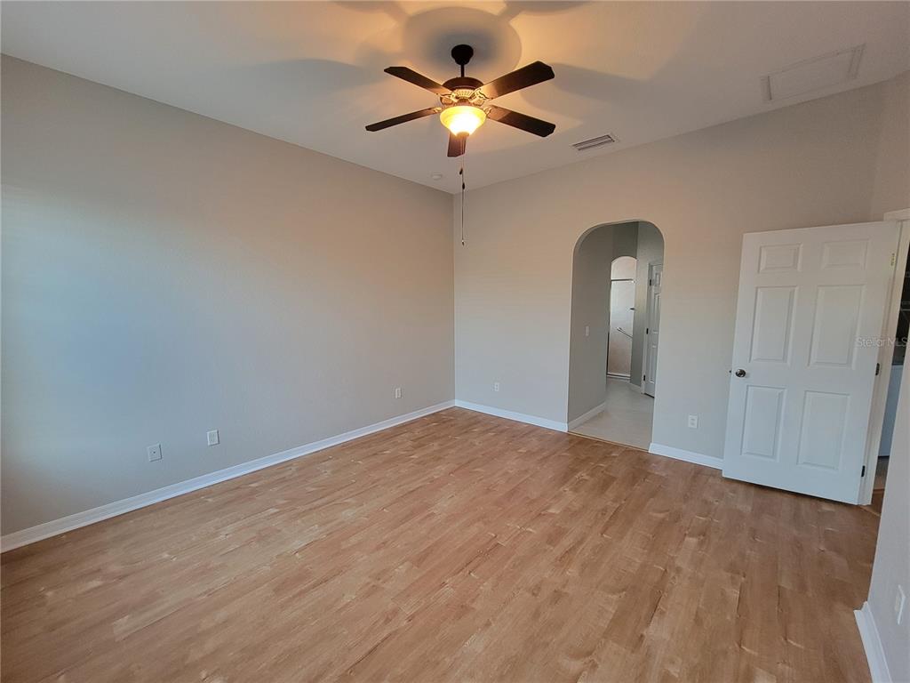 6243 Southwest 90th Street Ocala, FL 34476 - Photo 9 of 13 a view of an empty room with a chandelier fan