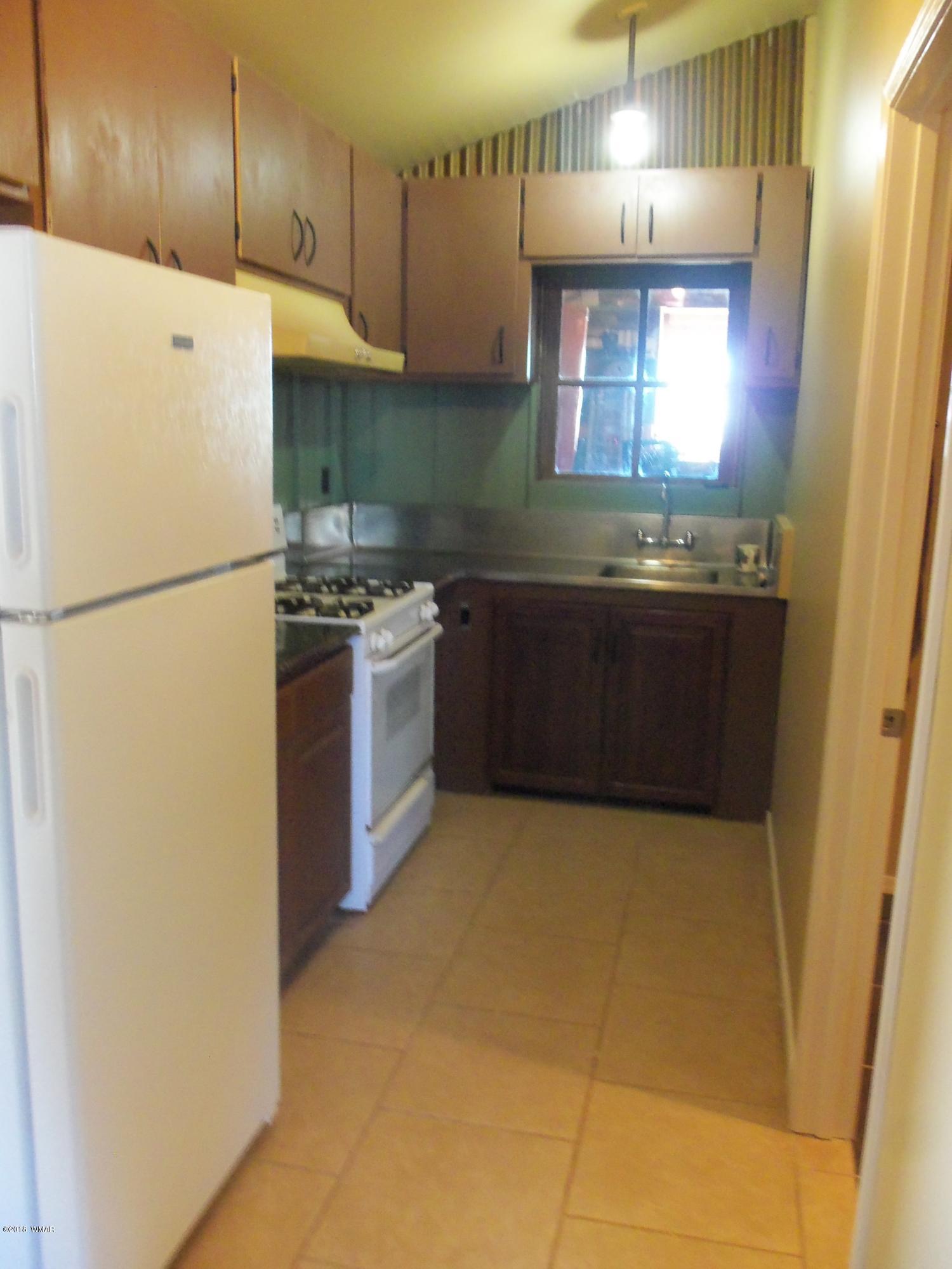 46 8307 Concho, AZ 85924 - Photo 14 of 34 a kitchen with a refrigerator a stove a sink and a microwave