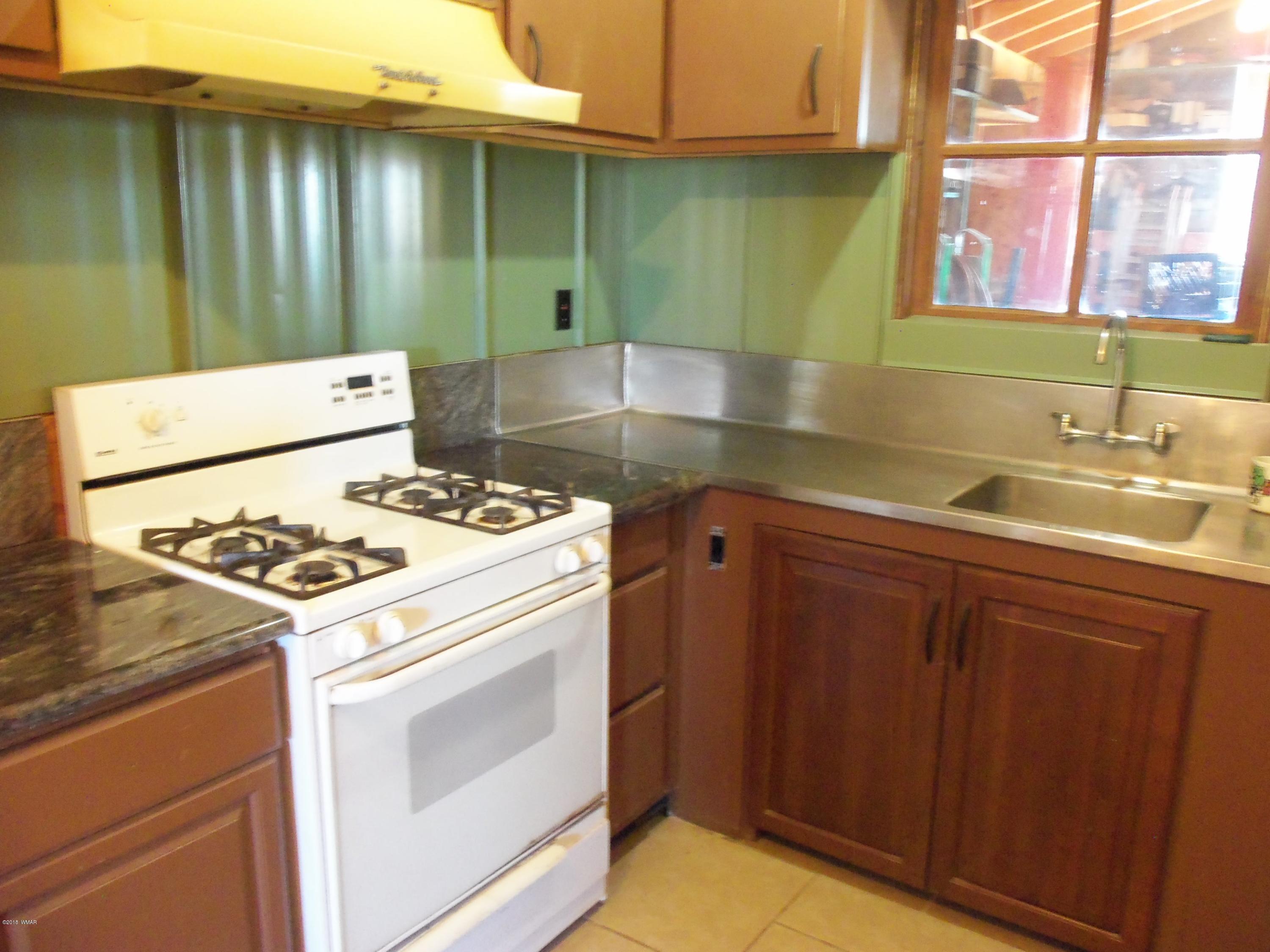 46 8307 Concho, AZ 85924 - Photo 15 of 34 a kitchen with a sink stove and cabinets