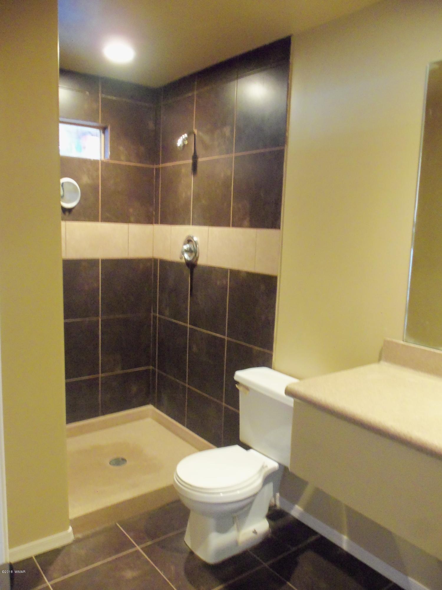 46 8307 Concho, AZ 85924 - Photo 18 of 34 a bathroom with a toilet and a shower