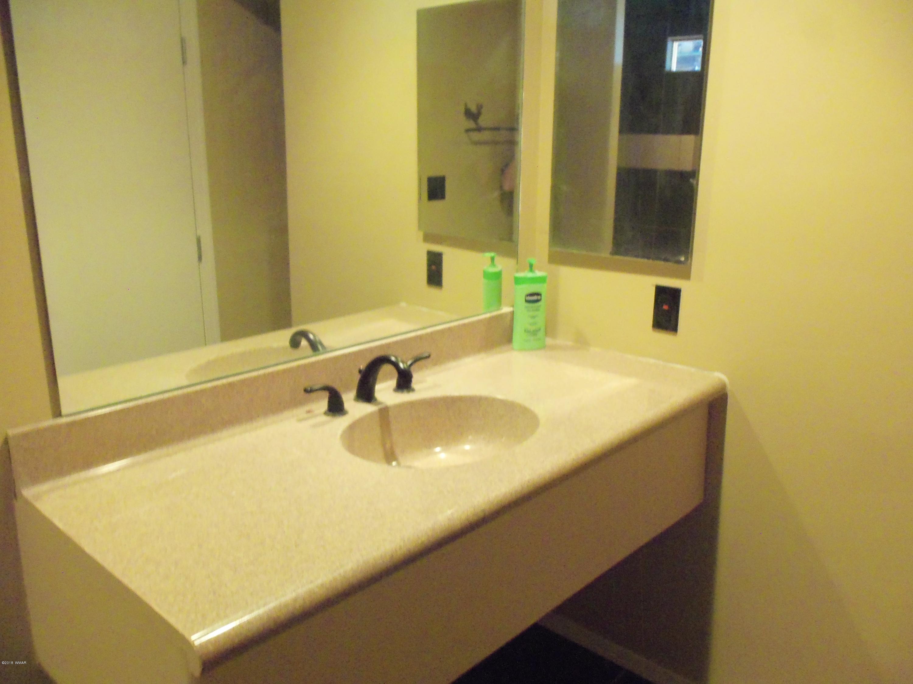 46 8307 Concho, AZ 85924 - Photo 19 of 34 a bathroom with a sink and a mirror