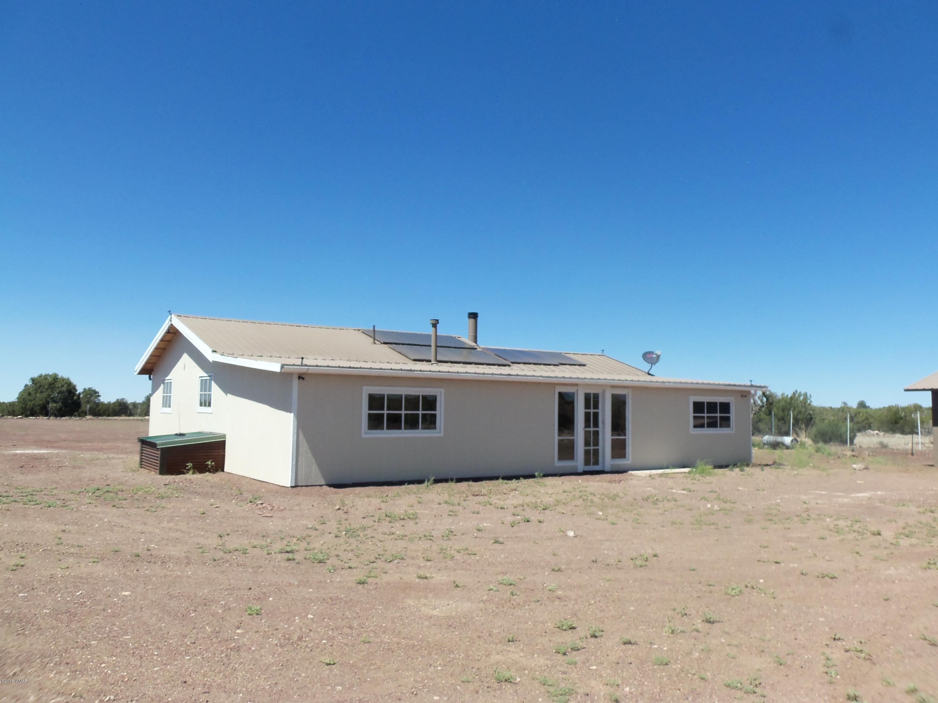 46 8307 Concho, AZ 85924 - Photo 2 of 34 a view of a white house with a yard