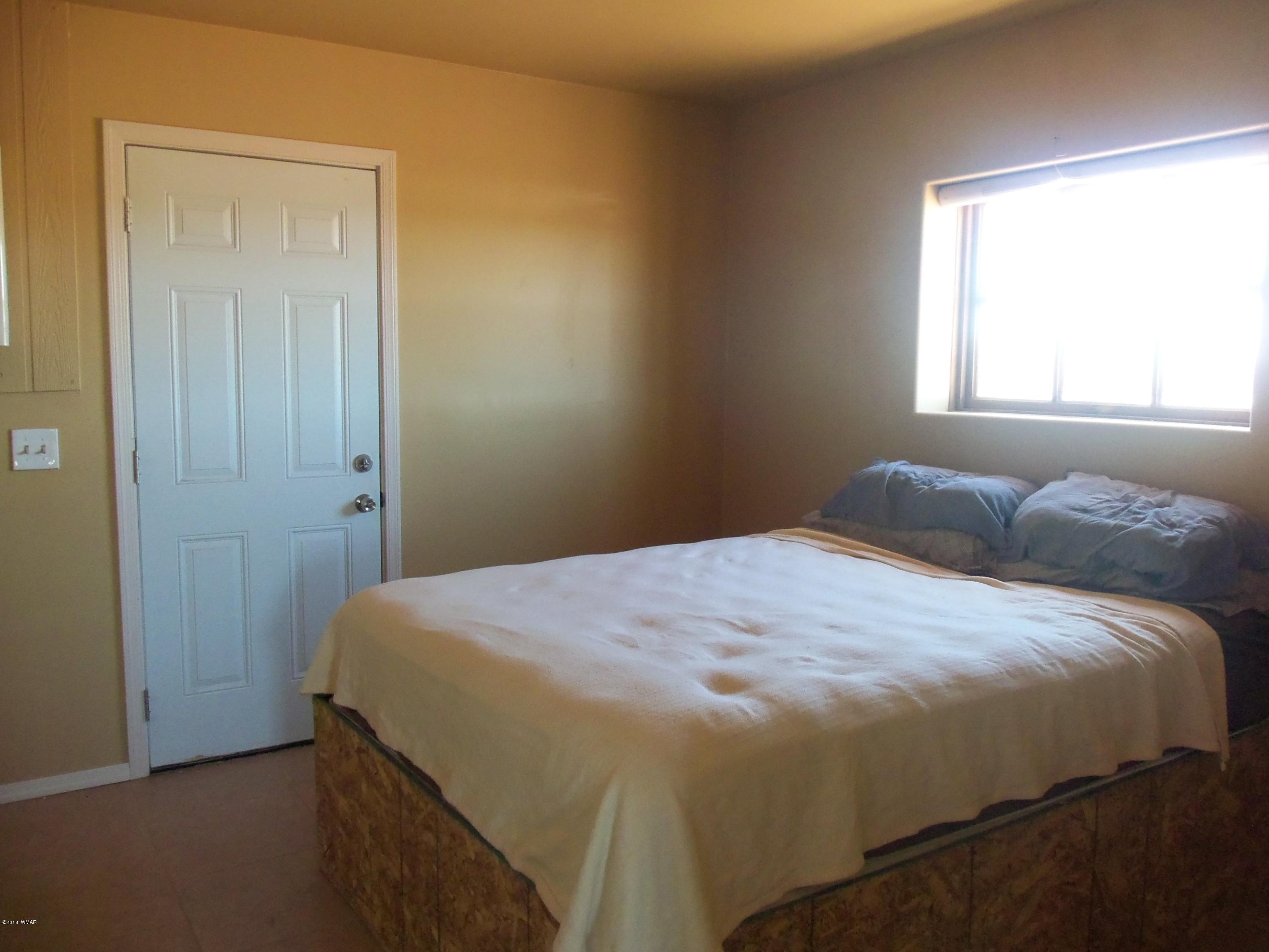46 8307 Concho, AZ 85924 - Photo 22 of 34 a bedroom with a bed and a window
