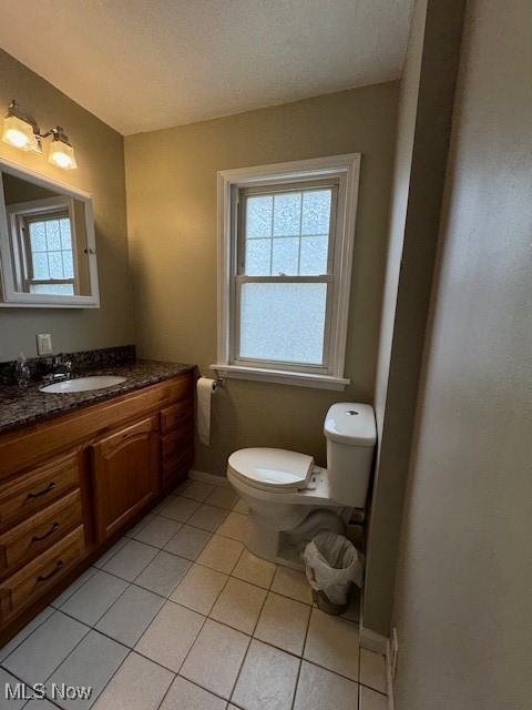 520 8th Street Struthers, OH 44471 - Photo 8 of 22 Bathroom with a textured ceiling, vanity, toilet, and tile patterned floors