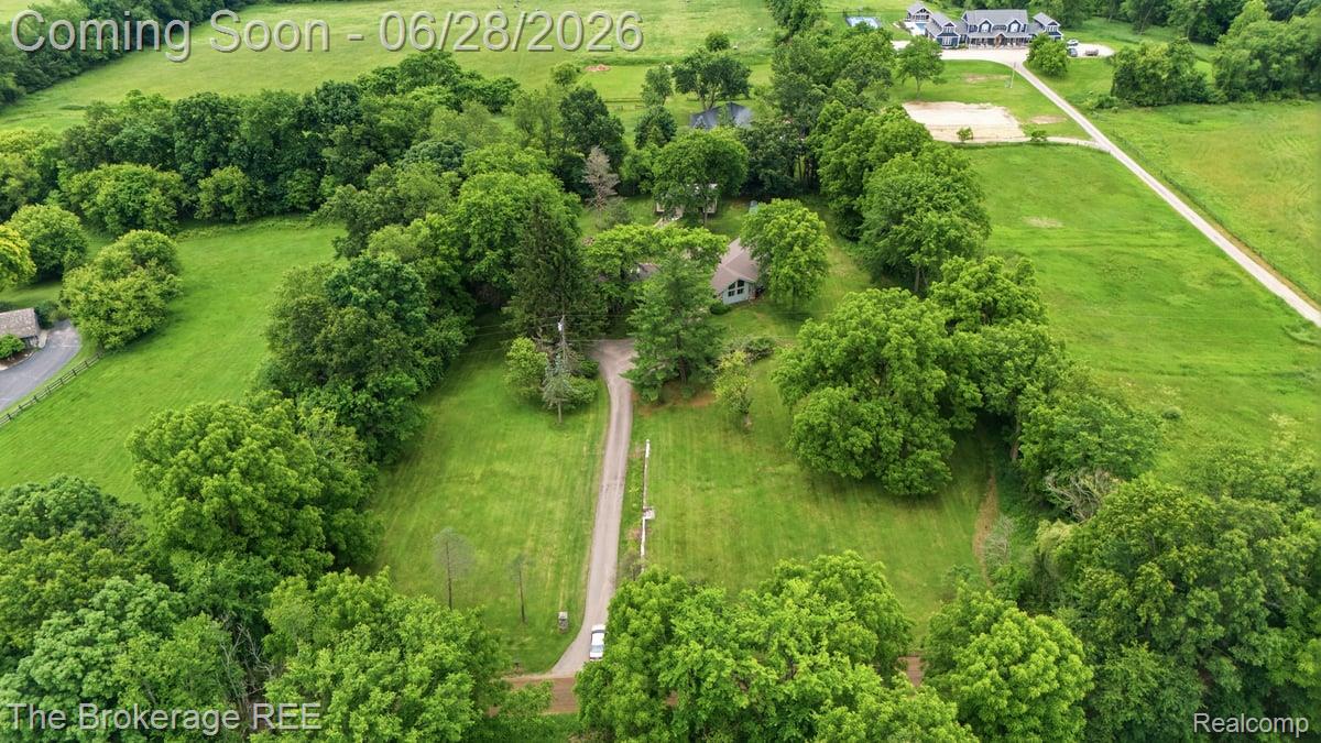 8475 Knox Road Clarkston, MI 48348 - Photo 69 of 71 Expansive green landscape featuring mature trees and a gravel driveway leading to a residence