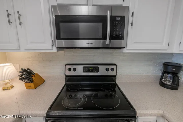 a kitchen with a stove and a microwave
