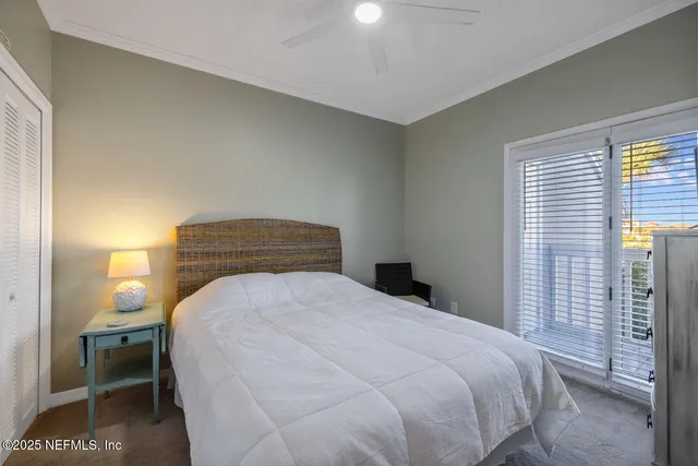 a bedroom with a bed and a potted plant