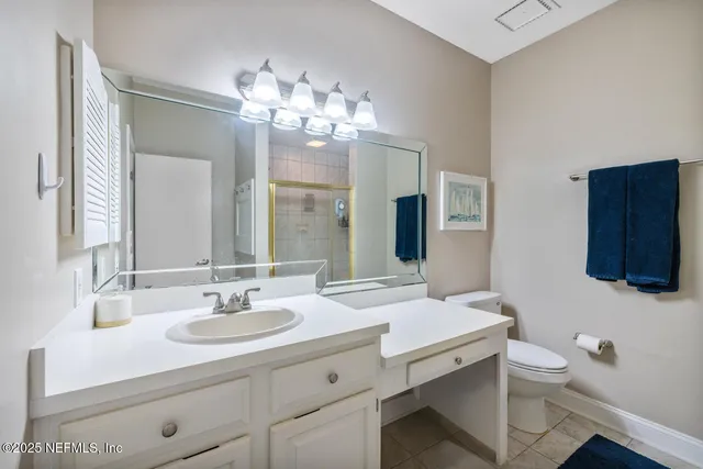a bathroom with a sink double vanity granite and a mirror