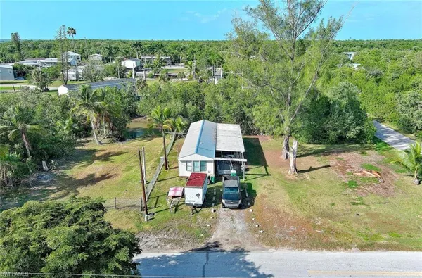 an aerial view of a house with a yard and lake view