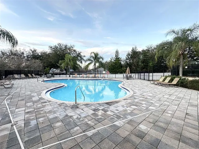 a view of a swimming pool with an outdoor space and seating area