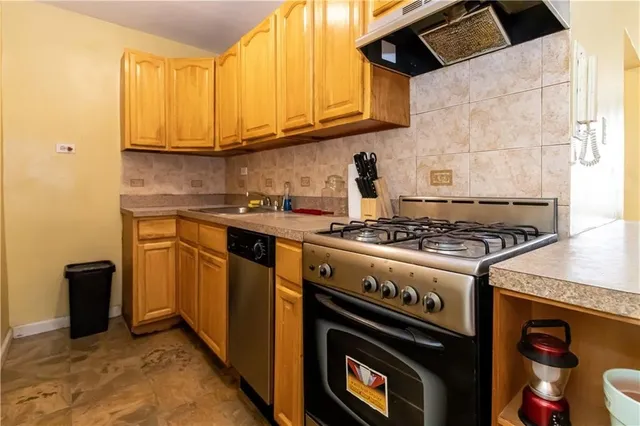a kitchen with stainless steel appliances granite countertop a stove and a microwave