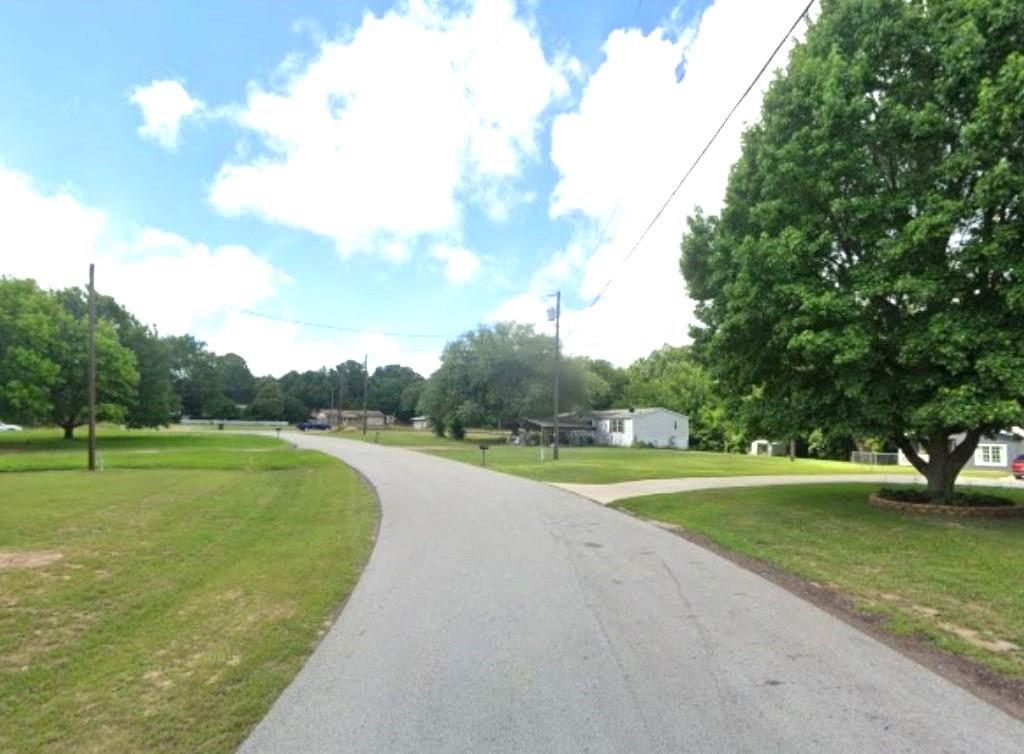 16958 Springcrest Lane Lindale, TX 75771 - Photo 4 of 8 a view of a golf course with a lake