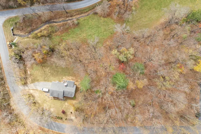 an aerial view of a house with pool outdoor seating and yard
