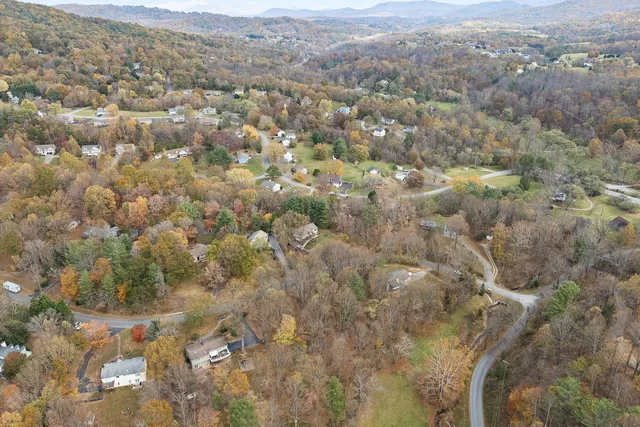 a aerial view of a residential houses with yard