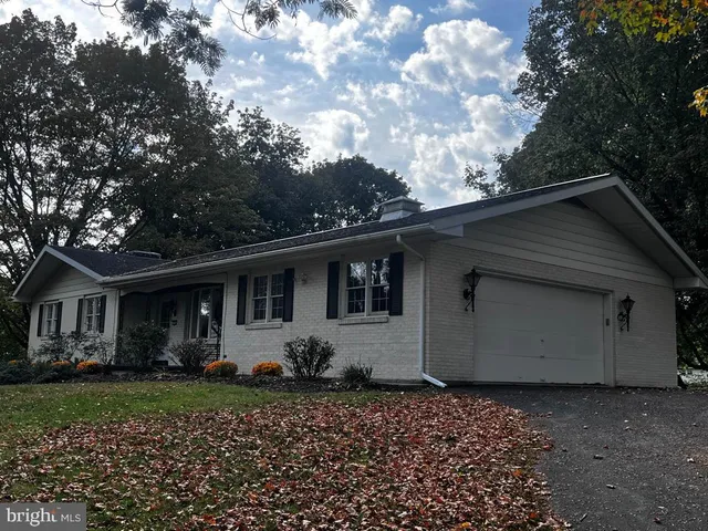 a view of house with backyard and garden