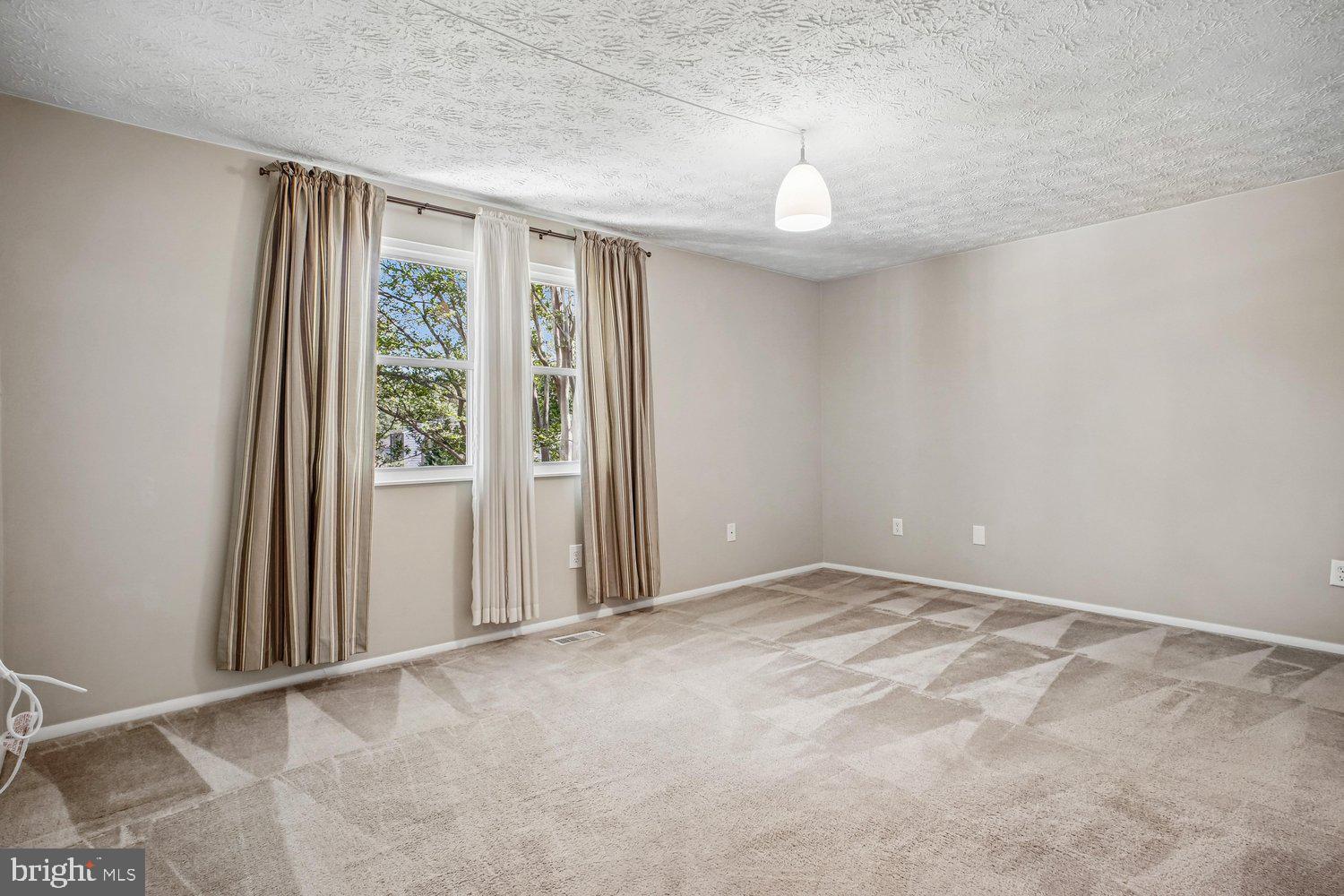 8491 Rippled Creek Court Springfield, VA 22153 - Photo 21 of 40 an empty room with windows and entrance