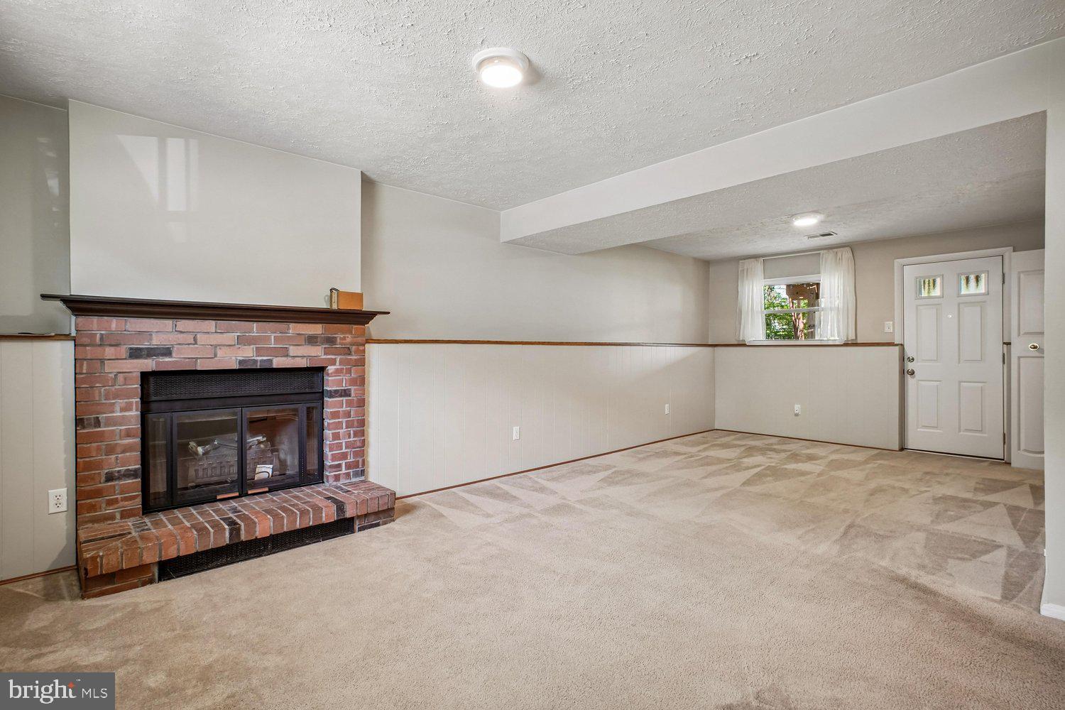 8491 Rippled Creek Court Springfield, VA 22153 - Photo 30 of 40 a view of empty room with kitchen fireplace